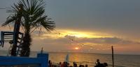 a group of people on a beach with a sunset at Villa Wiese in Katzow