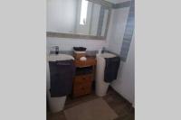 a bathroom with two sinks and a mirror at MAISON RESTAUREE 6 PERSONNES AU COEUR DU PERIGORD in Sourzac