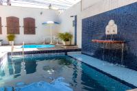 a swimming pool in a house with a swimming pool at Pousada Boulevard in Cabo Frio