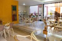 a restaurant with tables and chairs in a room at Pousada Boulevard in Cabo Frio