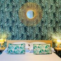 a bedroom with a bed with a mirror on the wall at Hôtel Jules in Le Touquet-Paris-Plage