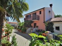 a courtyard of a house with flowers and plants at Holiday Home Milka 1 - ROJ315 by Interhome in Svetvinčenat