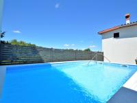 a swimming pool on the side of a house at Holiday Home Milka 1 - ROJ315 by Interhome in Svetvinčenat