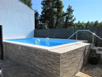 a hot tub in a backyard with a brick wall at Holiday Home Milka 1 - ROJ315 by Interhome in Svetvinčenat