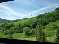 a view from a train window of a green field at Studio Soyouz Vanguard-12 by Interhome in Le Corbier