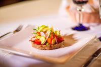 a piece of bread with vegetables on a plate on a table at The Explorean Selva Maya Kohunlich in Ruinas Kohunlích