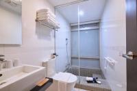 a bathroom with a toilet and a sink and a shower at Hotel Leisure Beitou in Taipei