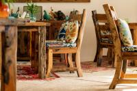 a dining room with a wooden table and chairs at Casa Paradis Boutique Hotel in Jambiani