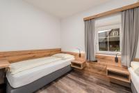 A bed or beds in a room at Landgasthof Bierfriedl