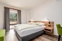 A bed or beds in a room at Landgasthof Bierfriedl