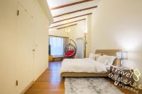 a bedroom with a bed and a hallway with a window at Tree Lake B&amp;B Hualien in Shuhu