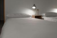A bed or beds in a room at Hostal Santa Cruz
