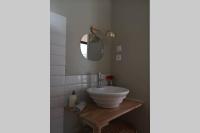 a bathroom with a white sink and a mirror at Le Petit Pèlerin in Ammerschwihr