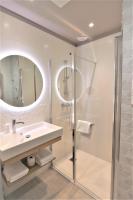 a bathroom with a sink and a shower at Hôtel Montaigne in Sarlat-la-Canéda