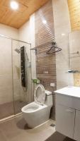 a bathroom with a toilet and a shower and a sink at Pure House B&amp;B in Ji&#39;an