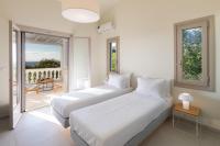 A bed or beds in a room at Ionian Garden Villas - Villa Sol