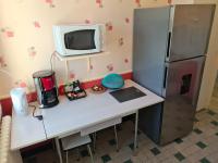 a kitchen with a desk with a refrigerator at Puy du Fou Maison 12 personnes 4mn du Grand Parc in Les Épesses
