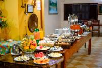 a buffet line with many plates of food and fruit at Hotel Pantanal Mato Grosso in Poconé
