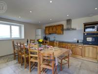 a kitchen with a wooden table and chairs in a kitchen at Gîte Panissières, 3 pièces, 8 personnes - FR-1-496-215 in Panissières