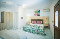 Postel nebo postele na pokoji v ubytování Rose Club Apartments
