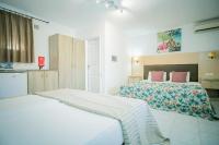 Postel nebo postele na pokoji v ubytování Rose Club Apartments