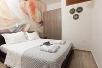 Postel nebo postele na pokoji v ubytování Asikiko Suites