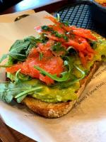 a sandwich with lettuce and tomatoes on a plate at Nisaki Mathraki B&B in Corfu Town