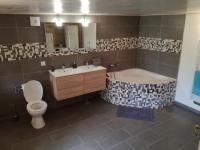 a bathroom with a tub and a toilet and a sink at Gîte de caractère en pleine nature in Bourg-de-Visa