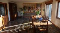 a dining room with a wooden table and chairs at Maison LGBT des Monts Bleus in Saint-Roman-de-Tousque