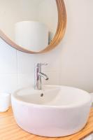 a white sink in a bathroom with a mirror at matcha wood - matcha home Koenigsmacker in Koenigsmacker