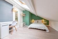 a bedroom with a bed and a desk and a chair at matcha wood - matcha home Koenigsmacker in Koenigsmacker