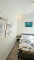 A bed or beds in a room at The Roof Garden - Bed&Breakfast