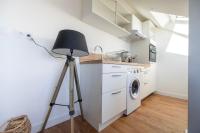 a tripod in a kitchen with a washing machine at Le Poulorio 12 - T2 - Proche Gare - dernier étage By Locly in Lorient