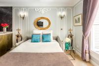 a bedroom with a bed with blue pillows and a mirror at Luxury 2 Bedroom 2,5 Bathroom Apartment - Champs Elysees in Paris