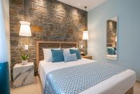 A bed or beds in a room at Αngelikon Luxurious Apartments