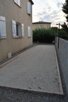 an empty driveway in front of a building at villa classée 4 étoiles avec piscine et boulodrome in Canet