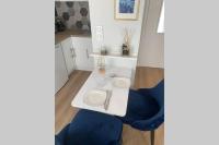 a white table and a blue chair in a room at APPARTEMENT DE CHARME EN CENTRE VILLE in Toulouse