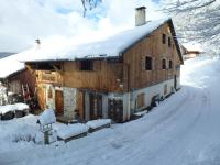 a large wooden house with snow on the roof at Beautiful renovated chalet near ski resort France in Arâches-la-Frasse