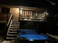 a bath tub in a room with a staircase with lights at Beautiful renovated chalet near ski resort France in Arâches-la-Frasse