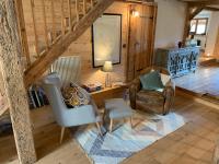 a living room with two chairs and a table at Beautiful renovated chalet near ski resort France in Arâches-la-Frasse