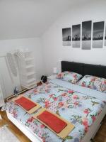 a bedroom with a bed with towels on it at Nenadovic Apartman in Obrenovac