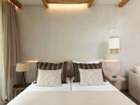 a bedroom with a white bed with two pillows at Atlantica Dreams Resort in Gennadi