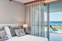 a bedroom with a bed and a view of the ocean at Atlantica Dreams Resort in Gennadi