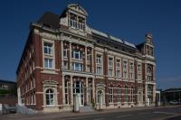 a large brick building with a tower on top of it at Weberei Bendix Hotel &amp; Appartements in Dülmen