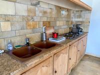 a kitchen counter with a sink and a stove at Magnifique villa de charme avec piscine in Casteljaloux