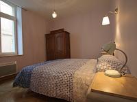 a bedroom with a bed and a table with a lamp at Gîte Épinal, 4 pièces, 6 personnes - FR-1-589-82 in Épinal