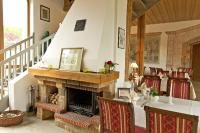 a living room with a fireplace and a table and chairs at Gästehaus Kloster Nimbschen in Grimma