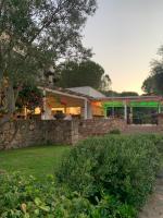 A garden outside Sardegna Costa Corallina Appartamento Luxury Vista Mare in splendido villaggio - IUN R6511