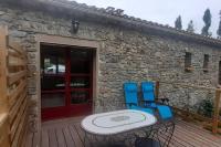 a patio with a table and chairs on a deck at Gite de la petite folie in Aizenay
