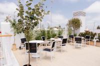 a patio with tables and chairs on a roof at Plaza Mina Suites - Adults Recommended by Luxury Suites Cadiz in Cádiz